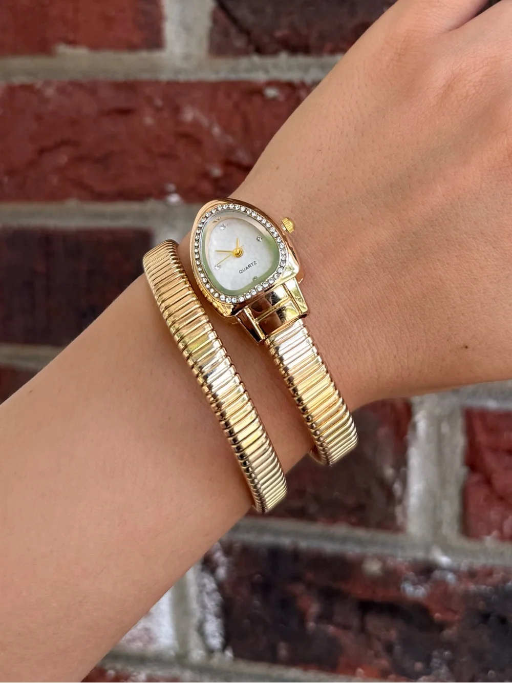 Gold serpentine bracelet watch